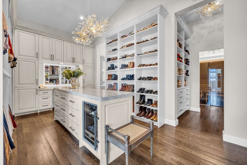 Dressing room shelving with shoes and a bench